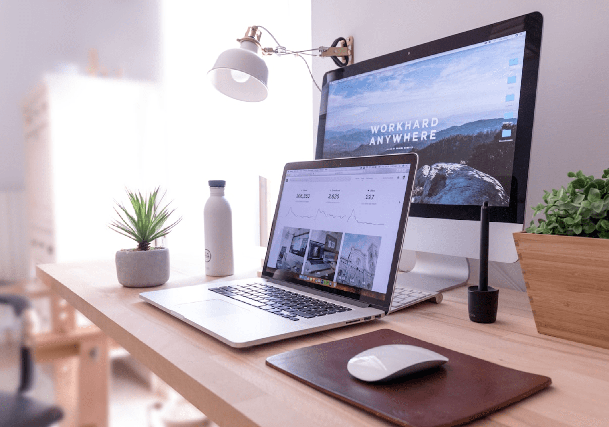 A laptop and desktop showing the website's launch.